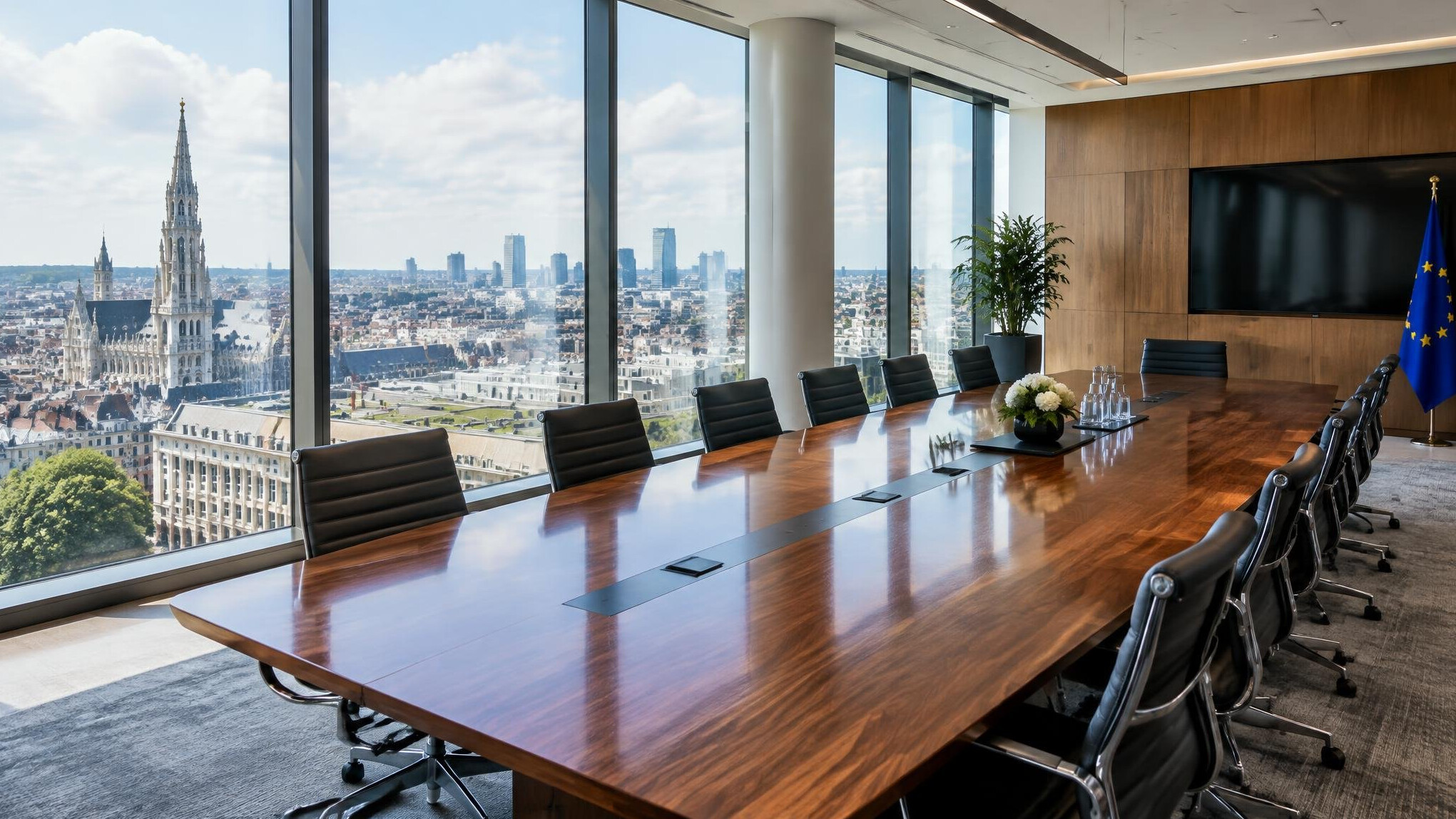 Empty modern boardroom with a long table and city view
